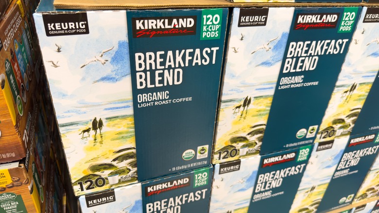 Multiple huge boxes of Kirkland Signature and Keurig branded breakfast blend coffee pods foil are stacked on a shelf