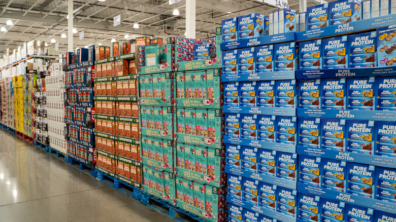 Packages of snacks line a Costco aisle