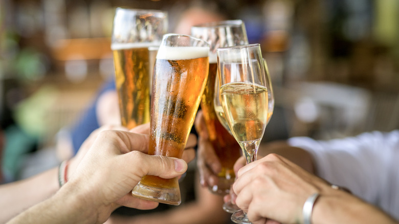 People toasting with clinking glasses