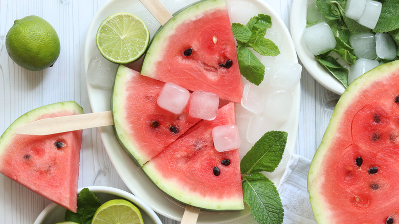 Watermelon slices with ice, mint, and lime