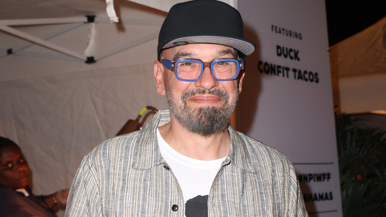 Michael Symon holding tacos at Tacos and Tequila event at Nassau Paradise Island Wine & Food Festival.