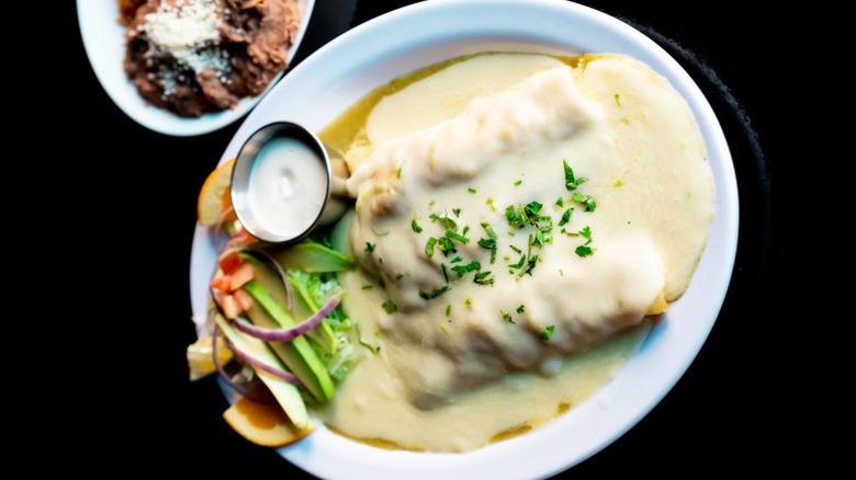 Enchiladas topped with a creamy sauce