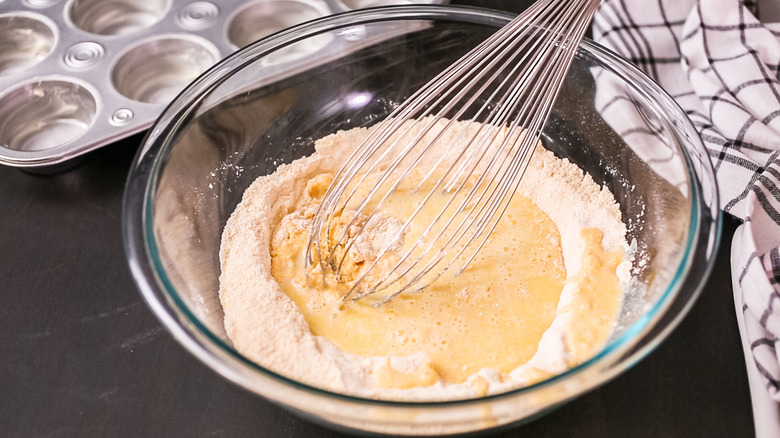 Mixing cornbread mix with whisk