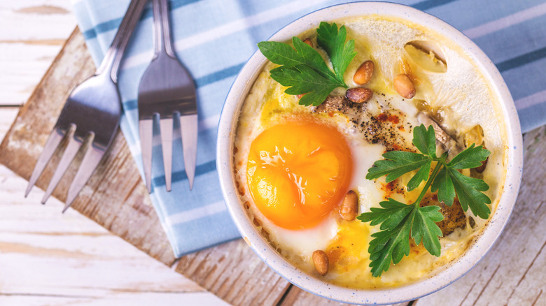 Eggs en cocotte with creme fraiche and fresh herbs