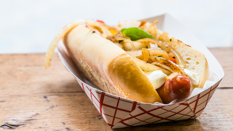 Seattle style hot dog in paper container