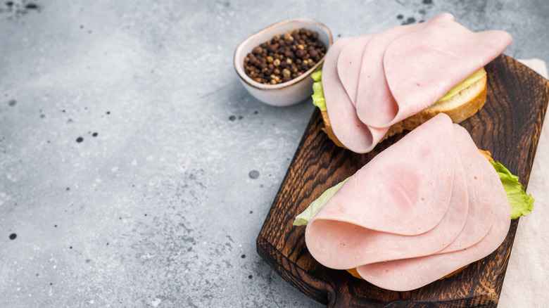 Cured turkey meat slices served on bread with lettuce.