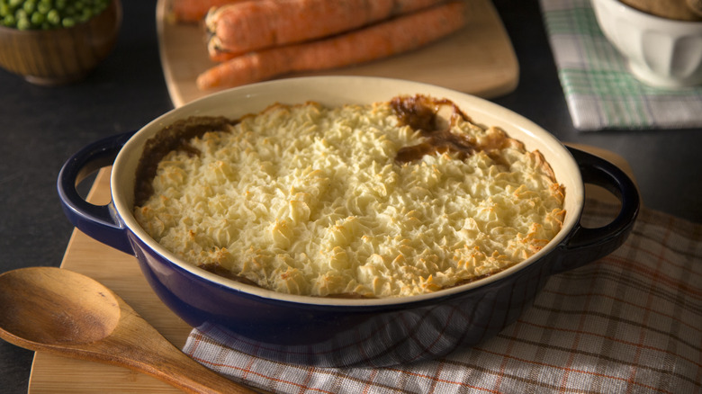 A shepherd's pie sits in an oval-shaped baking dish