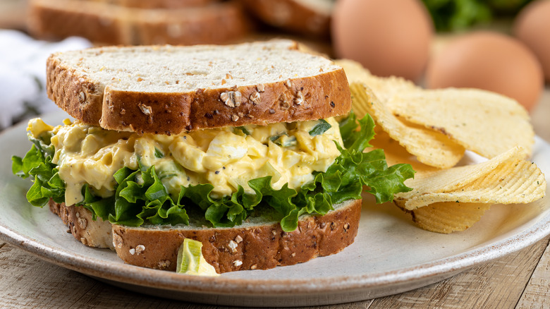 an egg salad sandwich with potato chips
