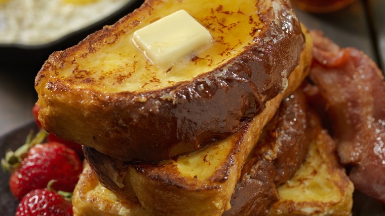 Stack of french toast with butter on top 
