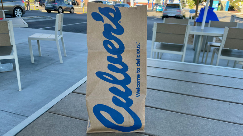A Culver's food bag outside.
