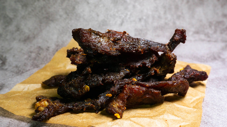 Homemade beef jerky laying on brown paper