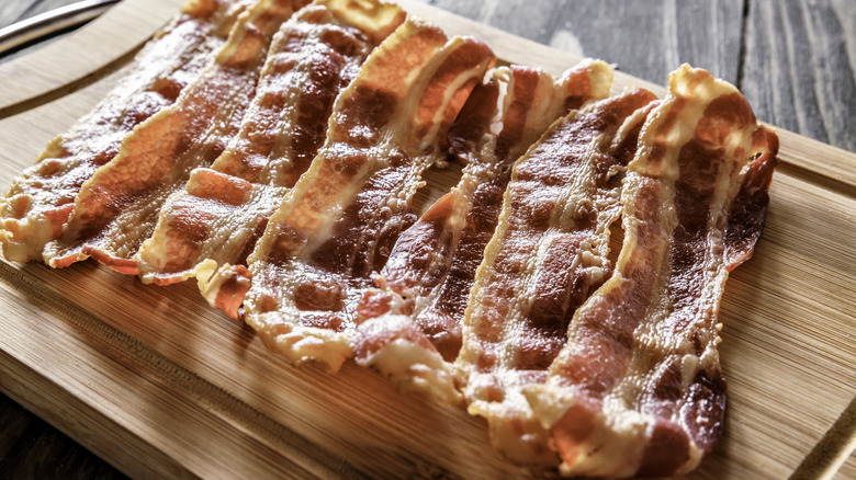 Cooked sliced bacon on a cutting board