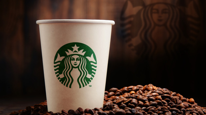 Starbucks cup with coffee beans