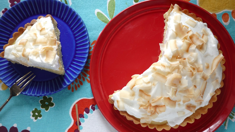 a coconut cream pie alongside a slice of the pie