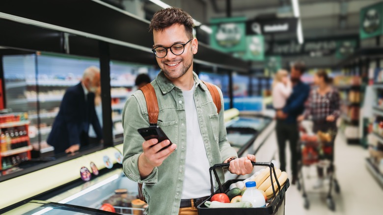 young man buying groceries at the store