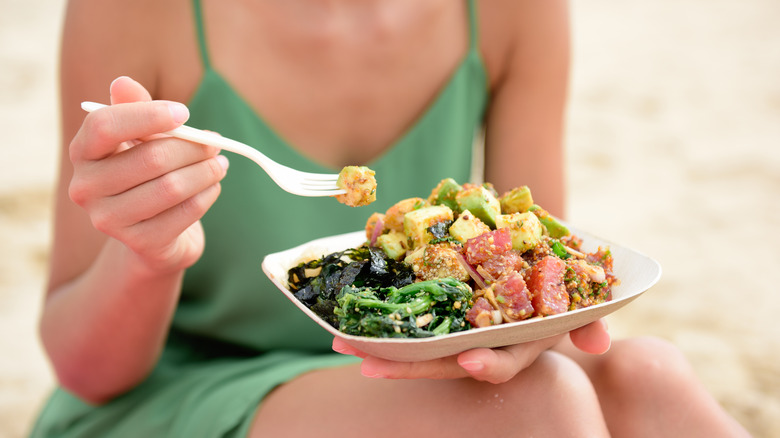 Woman eating poke