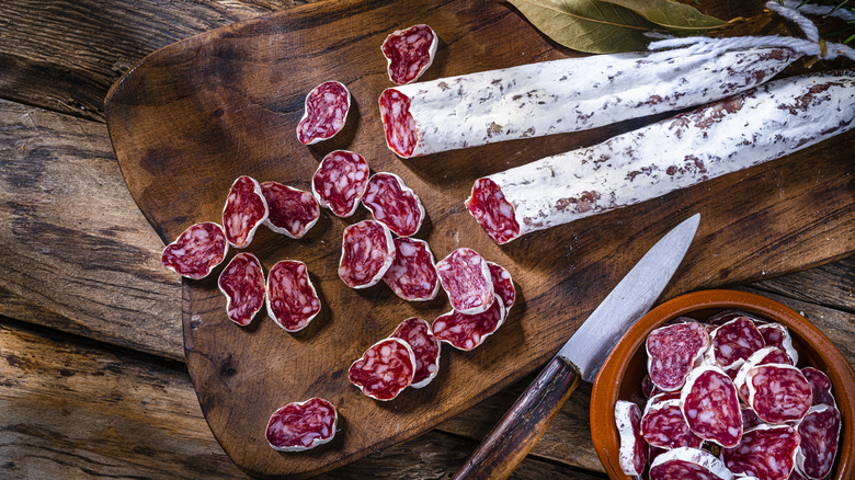 Salami on cutting board with knife