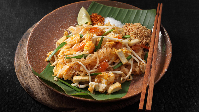 A bowl of pad Thai with chopsticks