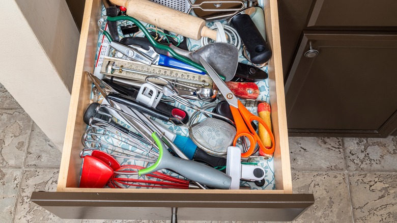 Junk drawer filled with kitchen tools.