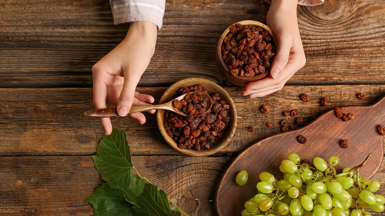 woman scooping raisins with spoon