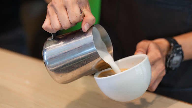 Starbucks barista making a coffee drink