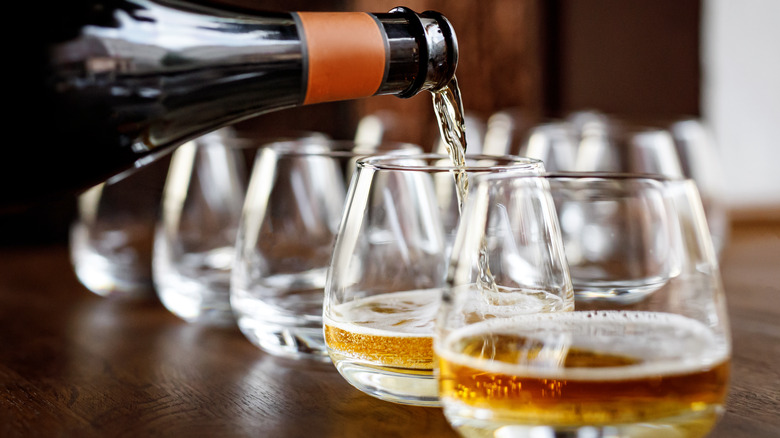 pouring cider into glasses