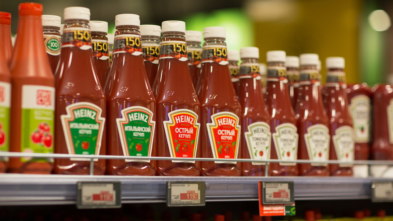 Bottles of ketchup on supermarket shelf