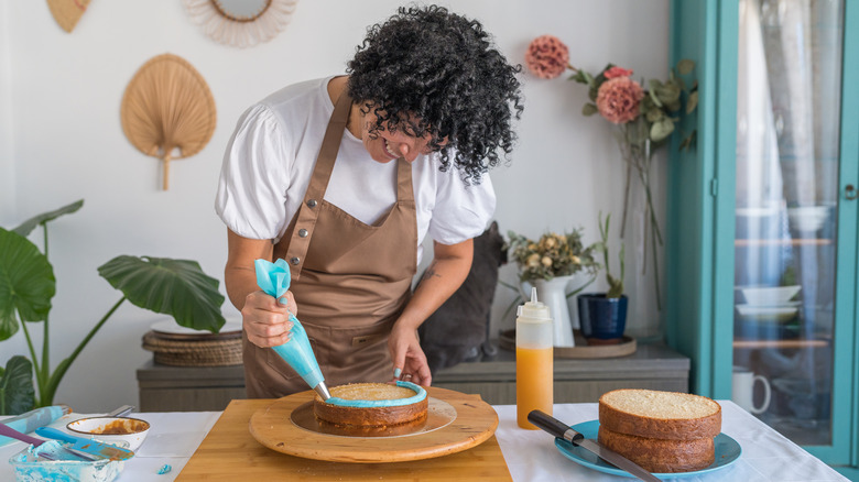 woman icing a cake