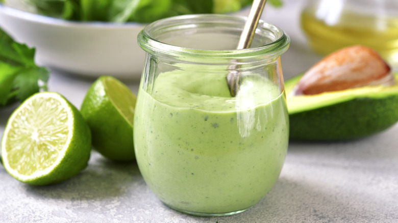Creamy avocado dressing in glass container