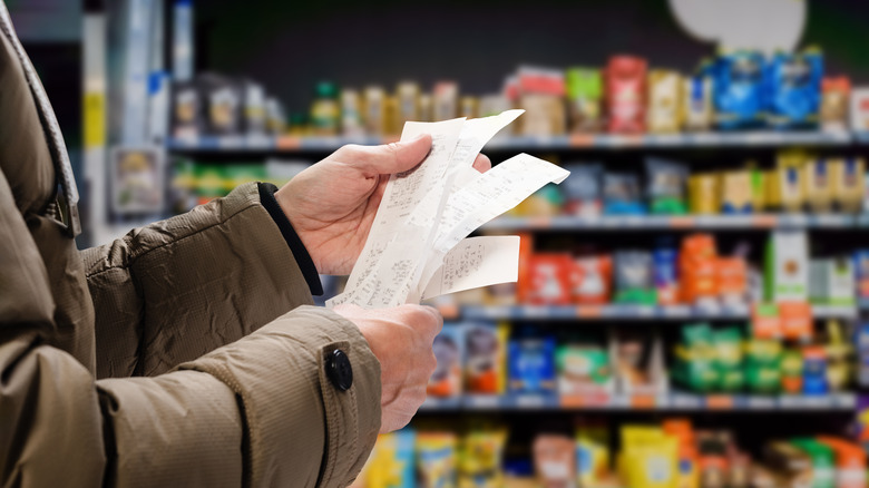 Person looking at grocery receipts