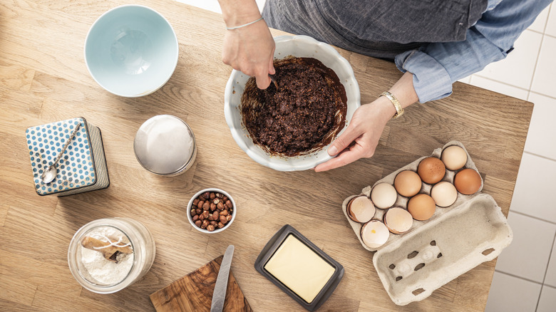 Chef mixing cake batter from scratch with fresh ingredients