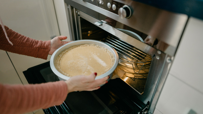 Putting cheesecake in the oven