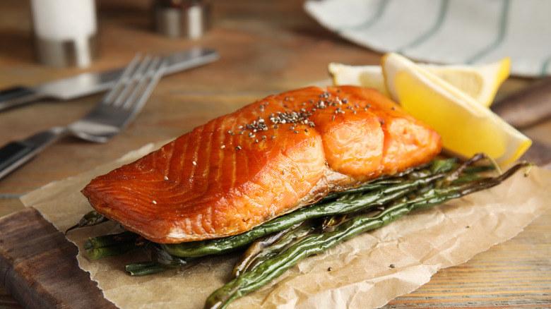 crispy salmon and vegetables sitting on parchment paper