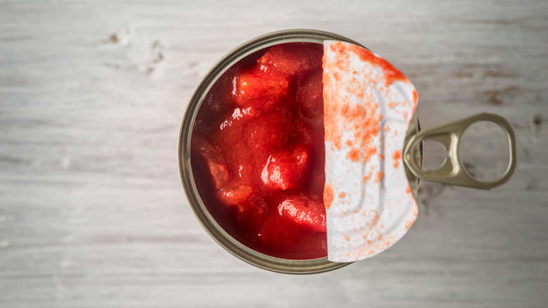 Top view of open can of tomatoes
