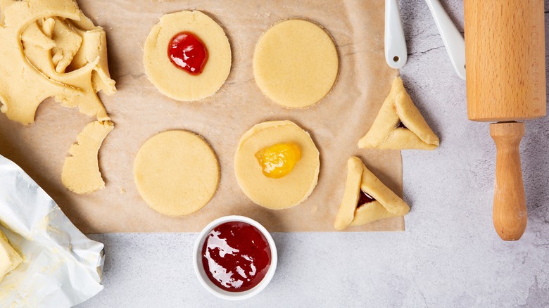 Hamantaschen dough rolled out and filled
