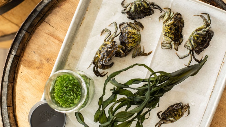 Green crabs on whiskey barrel
