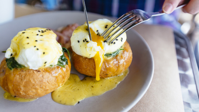 Two poached eggs on muffins on a plate