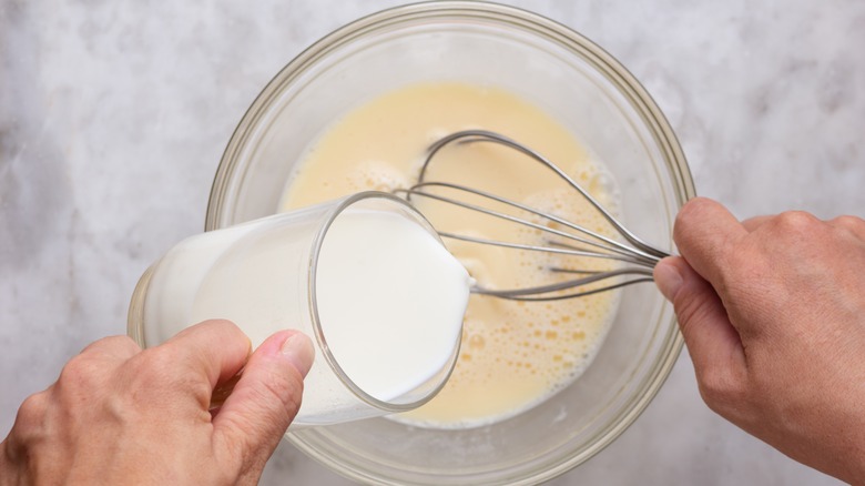 Mixing milk into eggs