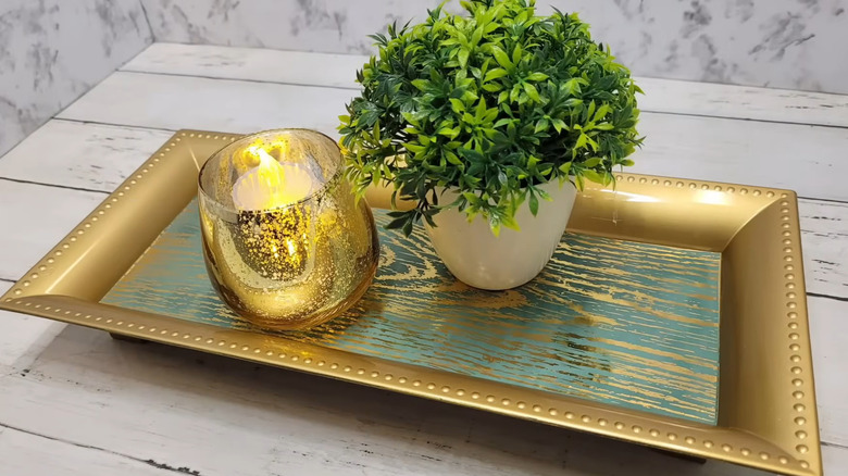 A YouTube craft project using the gold rectangular plastic charger tray from Dollar Tree