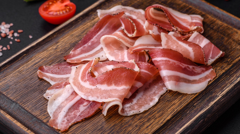 Pancetta slices on wood
