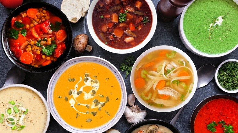 Top view of different types of soup in bowls