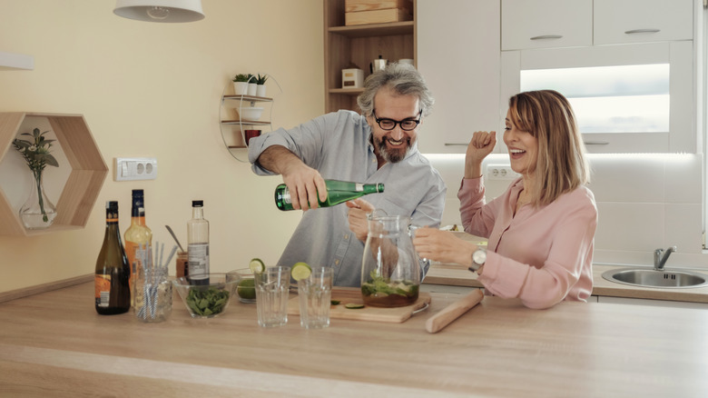 Couple making a pitcher of cocktails