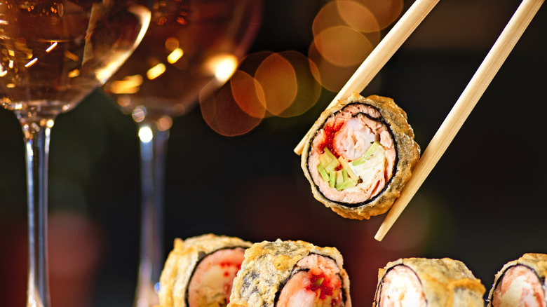 Fried sushi with white wine in background