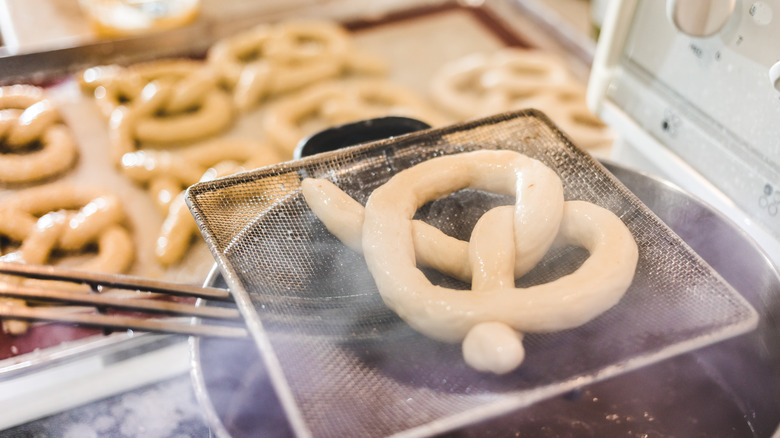 Pretzel dipped and removed from lye bath