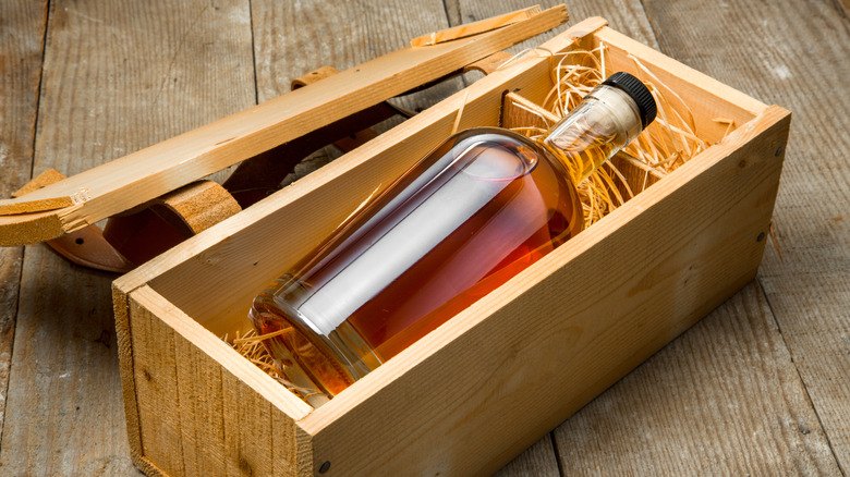 A bottle of whiskey stored in a wooden box