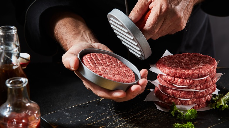 Making beef burgers with a burger press