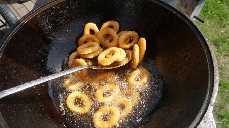 Frying onion rings in large round pan