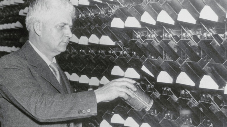 Clarence Saunders loads automatic supermarket vending