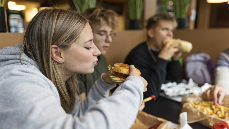 A family eats fast food at a table.