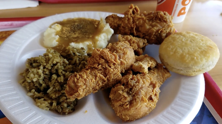 Plate of chicken, mashed potatoes, rice, and a biscuit from the Popeyes buffet